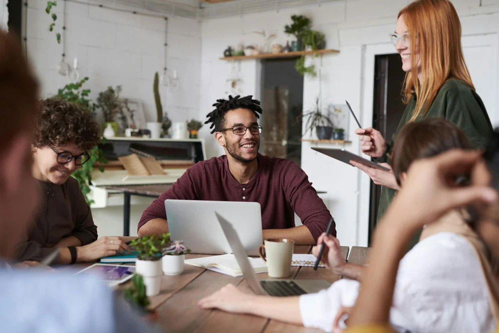 Équipe TOEIC® Étoile discutant autour d'une table en souriant